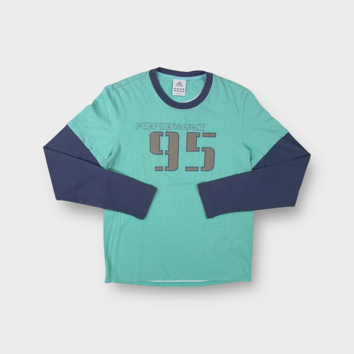 Adidas long-sleeve sweater in turquoise with a grey Performance 95 chest graphic.
