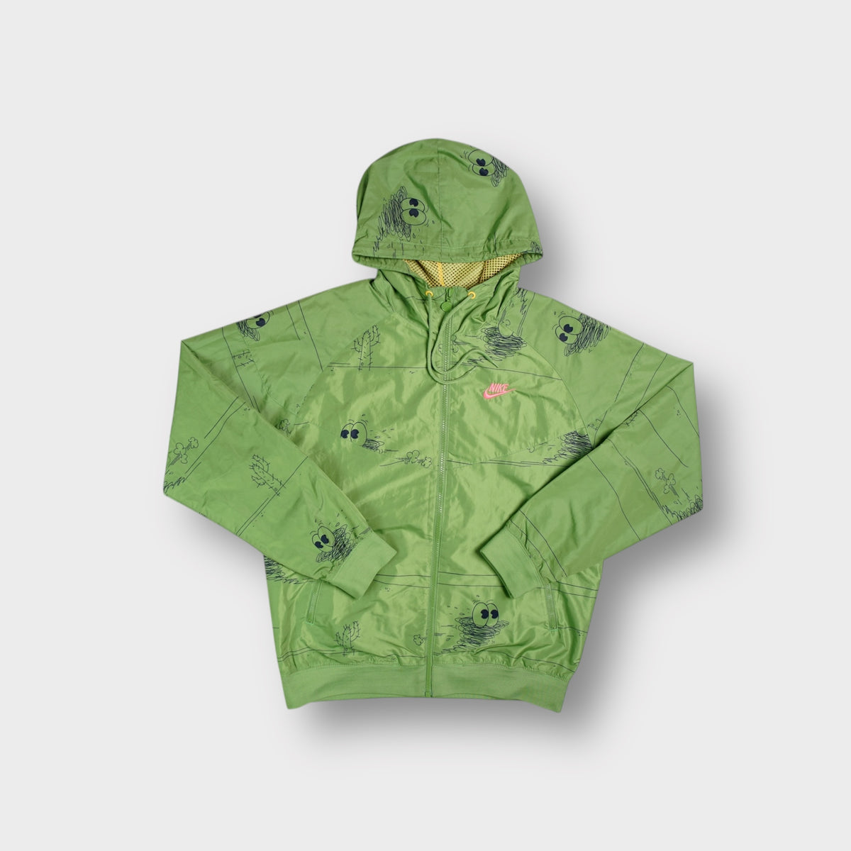 Green Nike full-zip hooded jacket featuring Misha Hollenbach cartoon graphic print