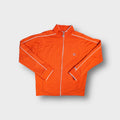 Orange Nike zip-up track jacket with white trim piping on sleeves and chest badge