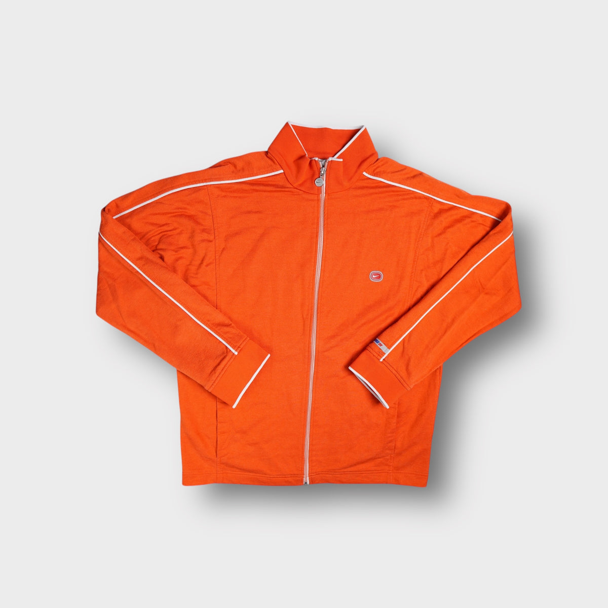 Orange Nike zip-up track jacket with white trim piping on sleeves and chest badge