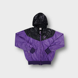 Nike jacket in purple and black featuring chevron paneling and an embroidered chest logo.