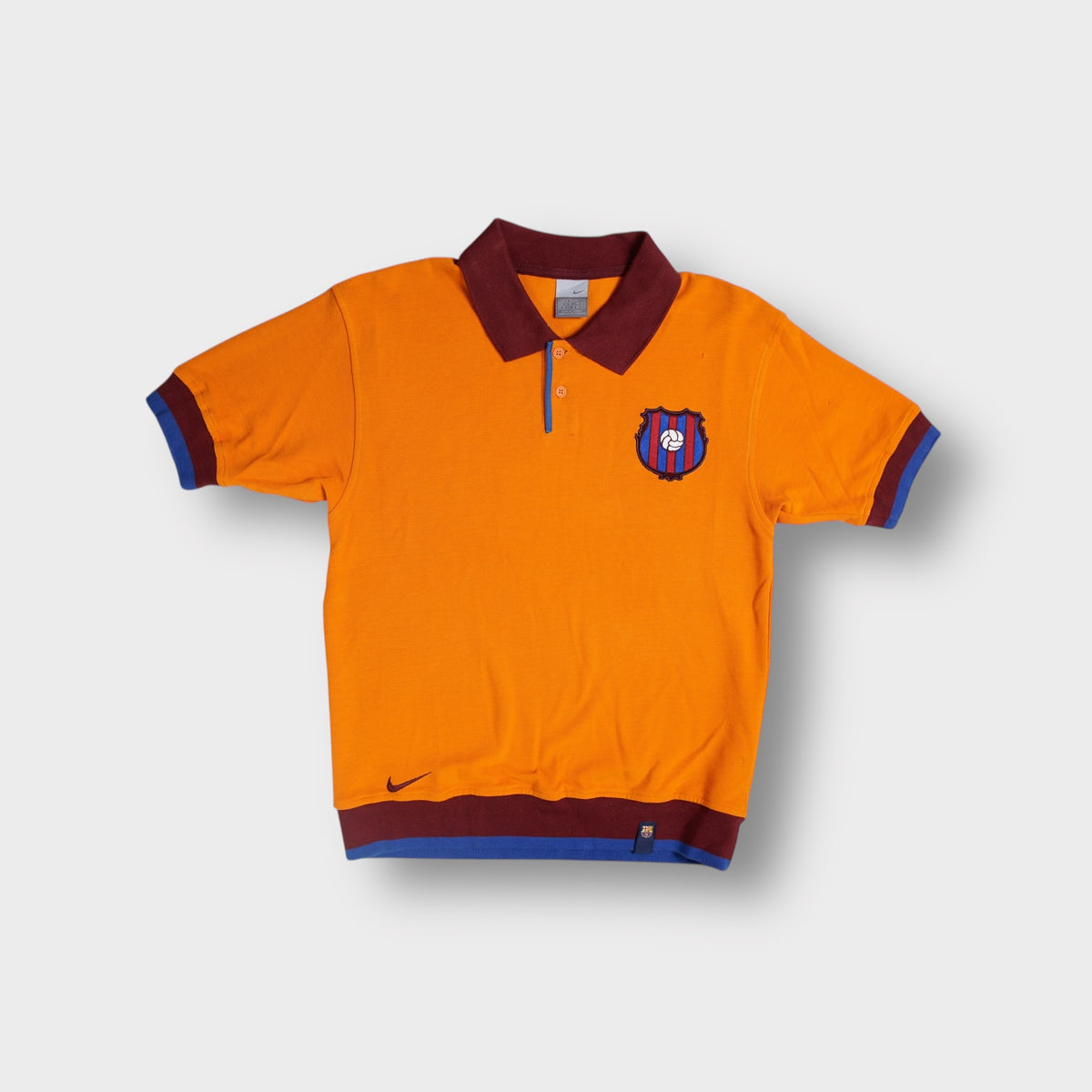Nike FC Barcelona polo shirt in orange with embroidered crest patch and collar