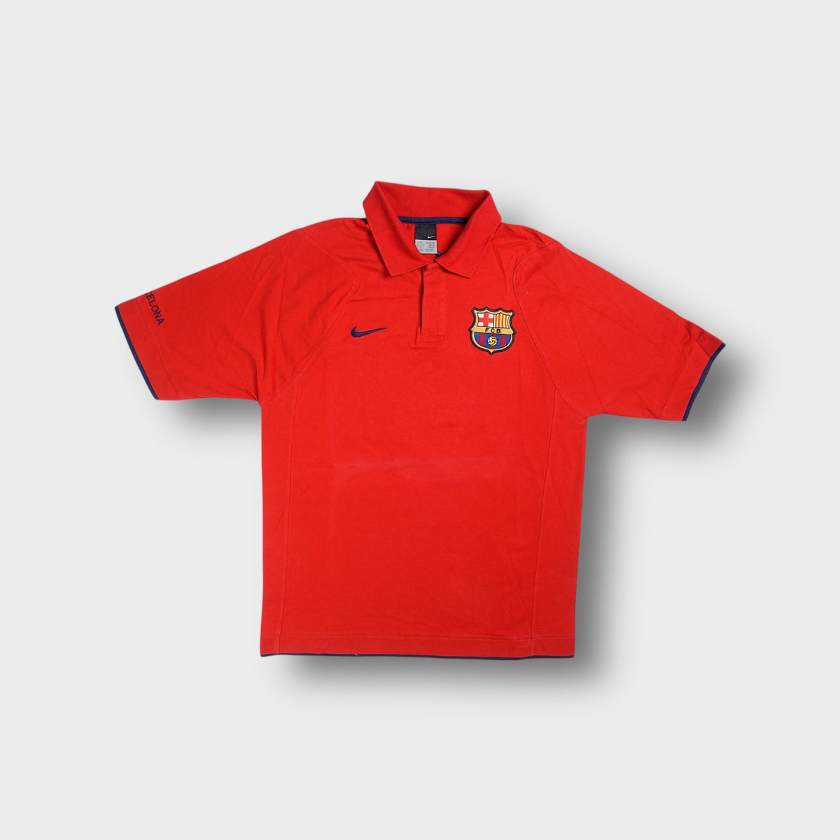 Nike FC Barcelona polo shirt in red featuring an embroidered team crest on the chest.