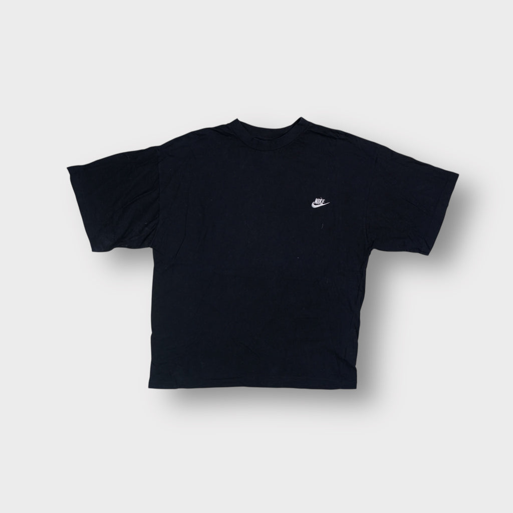 Nike T-Shirt in black featuring a white embroidered swoosh logo on the left chest