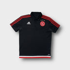 Adidas Ajax Amsterdam polo shirt in black with embroidered chest crest and red stripes.