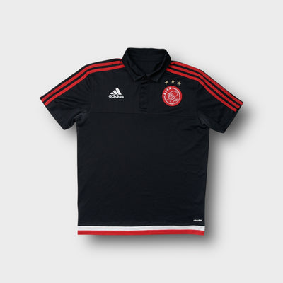 Adidas Ajax Amsterdam polo shirt in black with embroidered chest crest and red stripes.