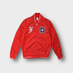Nike full-zip jacket in red featuring a French Football Federation FFF crest patch.
