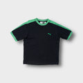Puma T-Shirt in black with green collar trim, shoulder stripes, and embroidered logo