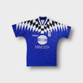 Blue Adidas football jersey featuring a white Minolta sponsor print and checked collar detail.