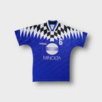 Blue Adidas football jersey featuring a white Minolta sponsor print and checked collar detail.