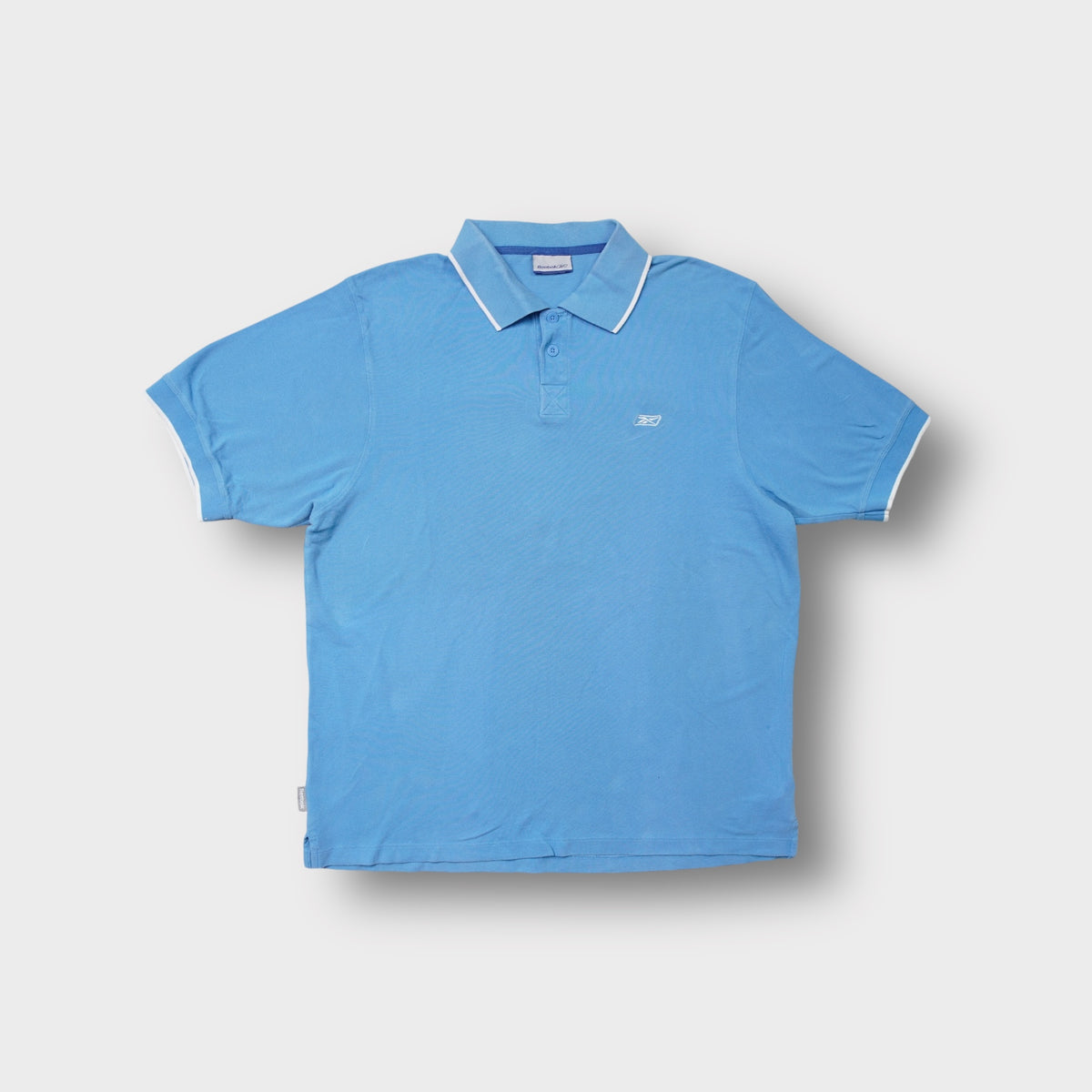 Reebok short sleeve polo shirt in light blue with white collar tipping and embroidered chest logo