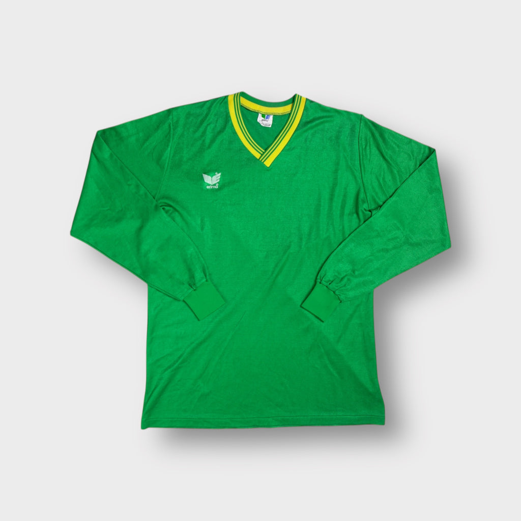 Green Erima jersey featuring a yellow striped V-neck trim and white chest logo
