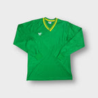 Green Erima jersey featuring a yellow striped V-neck trim and white chest logo