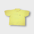 Yellow Lacoste polo shirt with a chest pocket and embroidered crocodile logo patch