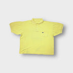 Yellow Lacoste polo shirt with a chest pocket and embroidered crocodile logo patch