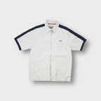 Beige Schott NYC short-sleeve zip shirt with navy shoulder stripes and embroidered chest logo
