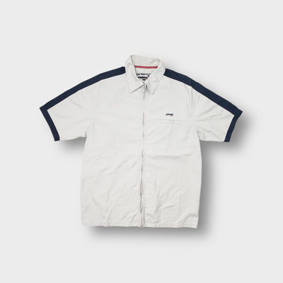 Beige Schott NYC short-sleeve zip shirt with navy shoulder stripes and embroidered chest logo