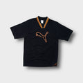 Puma T-Shirt in black with an orange ribbed V-neck collar and large chest patch logo