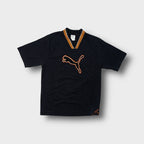 Puma T-Shirt in black with an orange ribbed V-neck collar and large chest patch logo