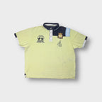 Peakstone yellow polo shirt with navy chest panel and embroidered polo graphics