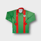 Green Klupp long-sleeve jersey with red stripes and a VELO crest patch