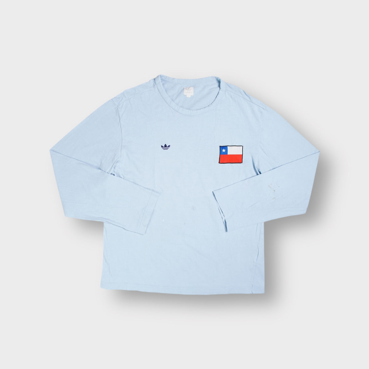Adidas light blue long-sleeve sweater with a small Trefoil logo and Chile flag patch on chest