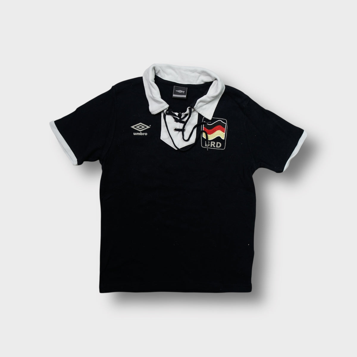 Umbro black lace-up shirt with a white collar and BRD crest on the chest