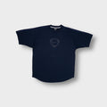 Nike shirt in navy blue featuring a centered shield logo and raglan shoulders