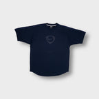 Nike shirt in navy blue featuring a centered shield logo and raglan shoulders