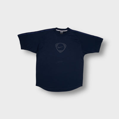 Nike shirt in navy blue featuring a centered shield logo and raglan shoulders