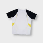 Nike training shirt in white featuring black raglan sleeves and yellow accent panels.