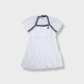 White Nike tennis dress featuring striped trim and an embroidered court logo patch