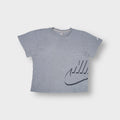 Nike grey T-Shirt with a stylized swoosh graphic on the lower left hem