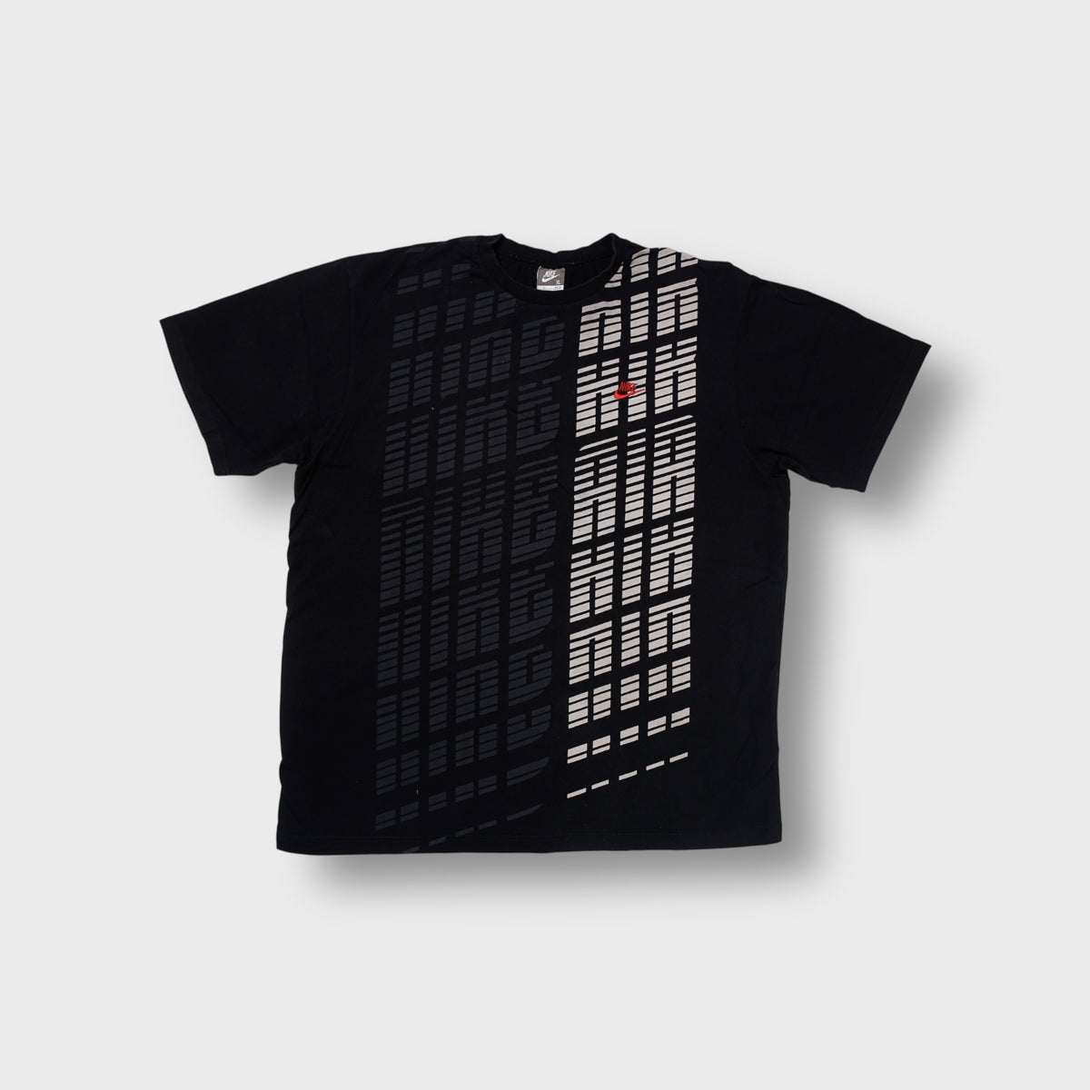 Black Nike Air T-Shirt with a grey vertical graphic print and small red swoosh
