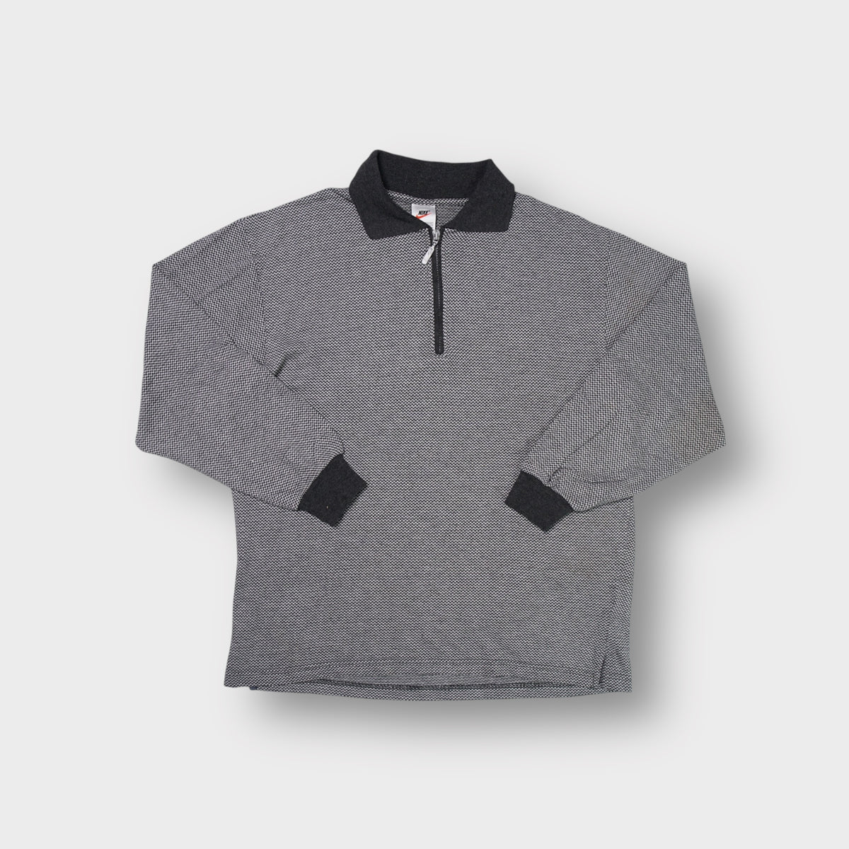 Grey Nike polo sweater with half-zip closure and dark contrast collar