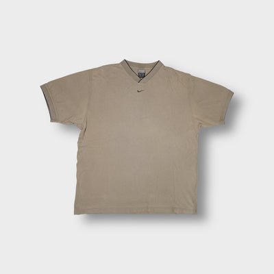Nike T-Shirt in beige featuring a ribbed V-neck collar and embroidered chest swoosh