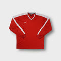 Red Nike long-sleeve jersey with white shoulder panels and an embroidered swoosh