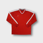 Red Nike long-sleeve jersey with white shoulder panels and an embroidered swoosh