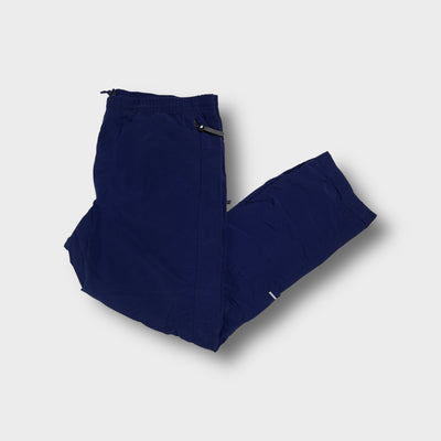 Adidas navy blue trackpants featuring side zip pockets and tonal embroidered logo