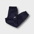 Puma trackpants in navy blue featuring an embroidered white logo on the thigh