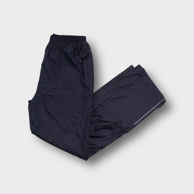 Umbro dark grey trackpants featuring an embroidered logo near the pocket side zipper