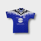 Adidas football jersey in blue with black and white graphic pattern and Minolta print.