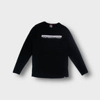 The North Face long-sleeve sweater in black featuring a printed chest logo graphic