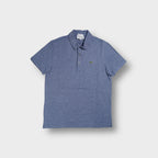 Blue Lacoste polo shirt with embroidered crocodile logo on the chest