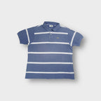 Lacoste polo shirt in blue with horizontal white stripes and embroidered chest logo.