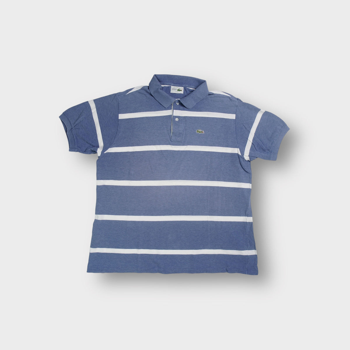 Lacoste polo shirt in blue with horizontal white stripes and embroidered chest logo.