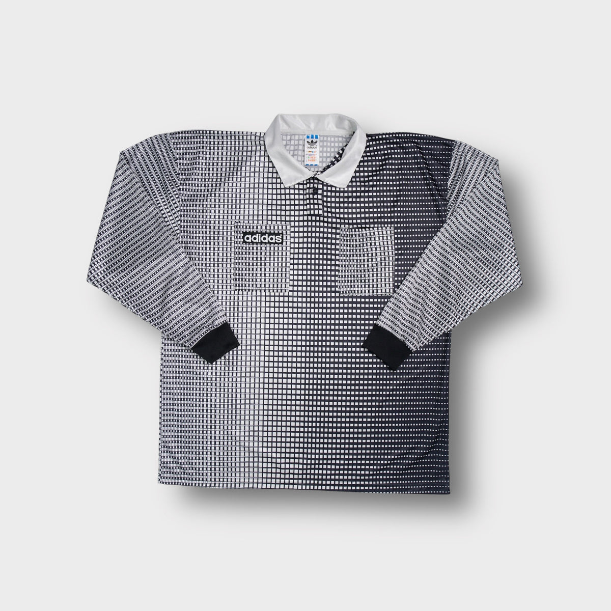 White Adidas long-sleeve referee jersey with a geometric grid print and collar