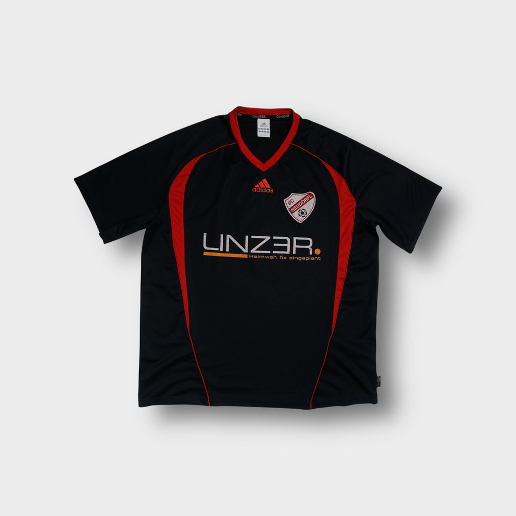 Adidas jersey in black featuring red V-neck collar, SC Neudörfl crest, and sponsor print