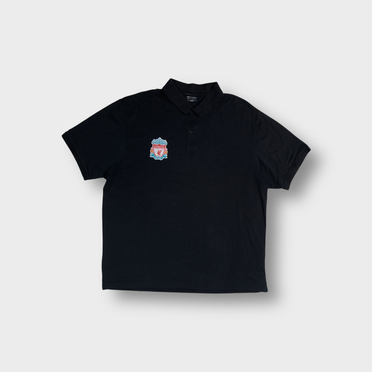 Champion black polo shirt displaying an embroidered FC Liverpool crest on the chest
