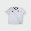 White Nike USA national football team jersey with embroidered crest and navy collar